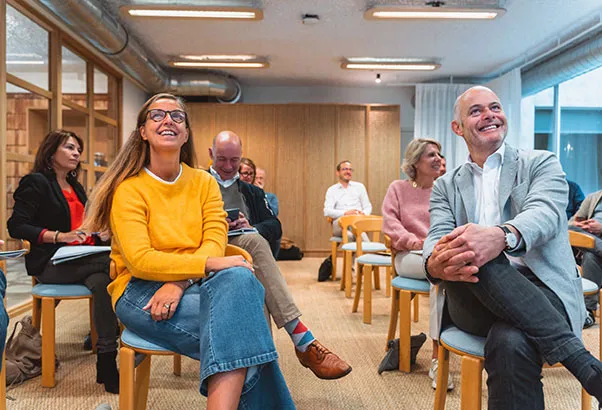 Entrepreneurs laughing together during a Revival group session